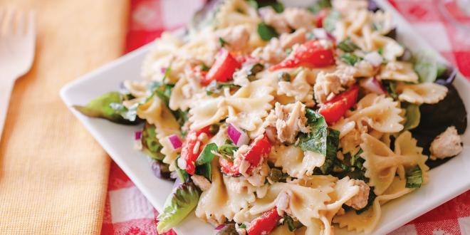 a plate of pasta with tuna and vegetables