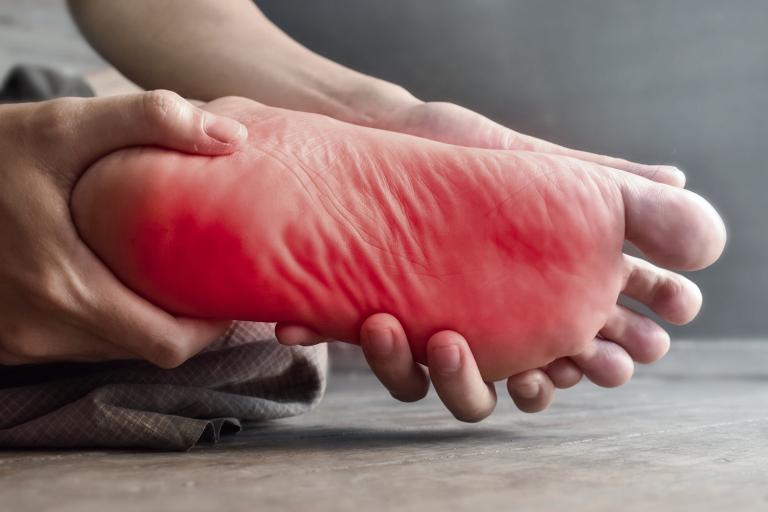 a foot writhing in pain and discomfort