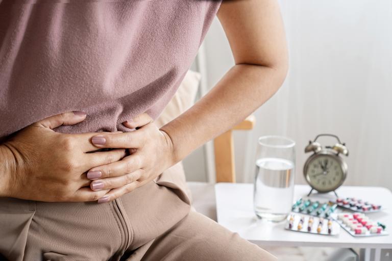 a woman clutching her abdomen in pain